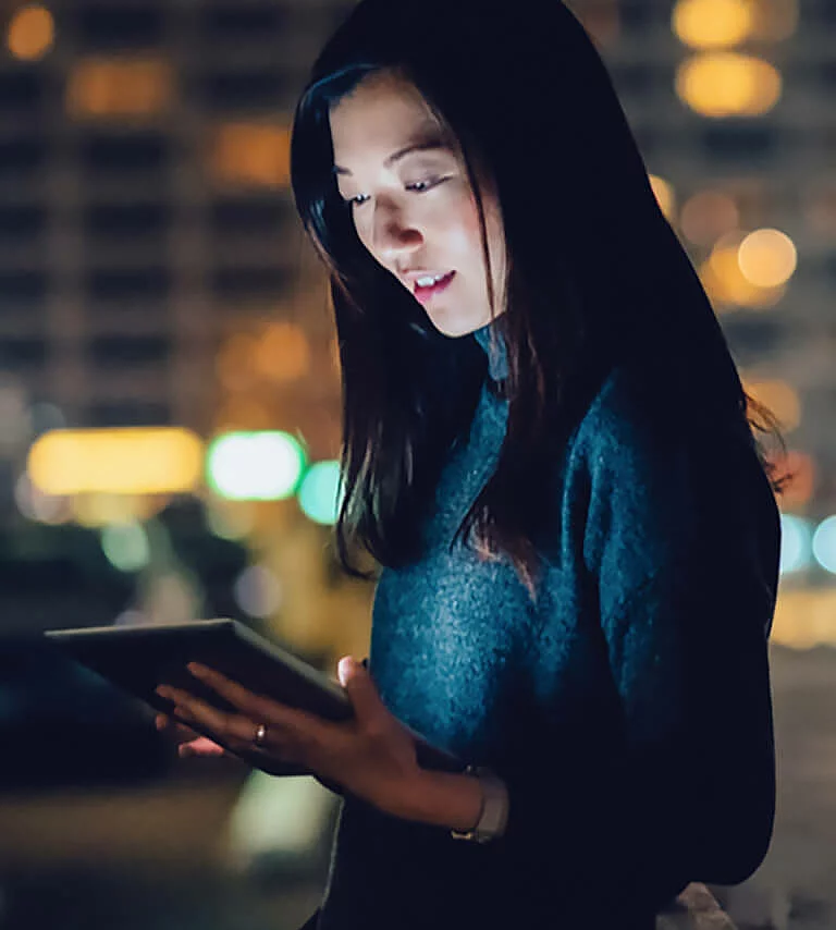 Imagery An example of the visual language is a photo of a young lady looking at a tablet in front of a nighttime city backdrop