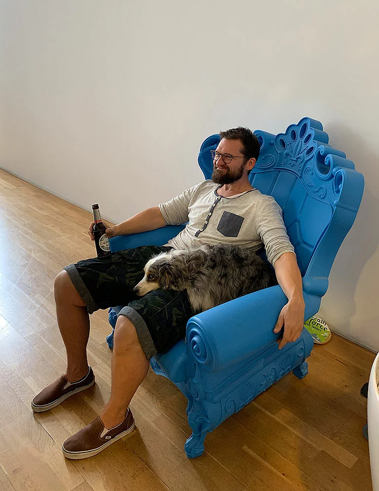 Leisure time Foto: SNK Geschäftsführer André Bachofner sitzt mit seinem Hund Henry auf einem blauen Thron.